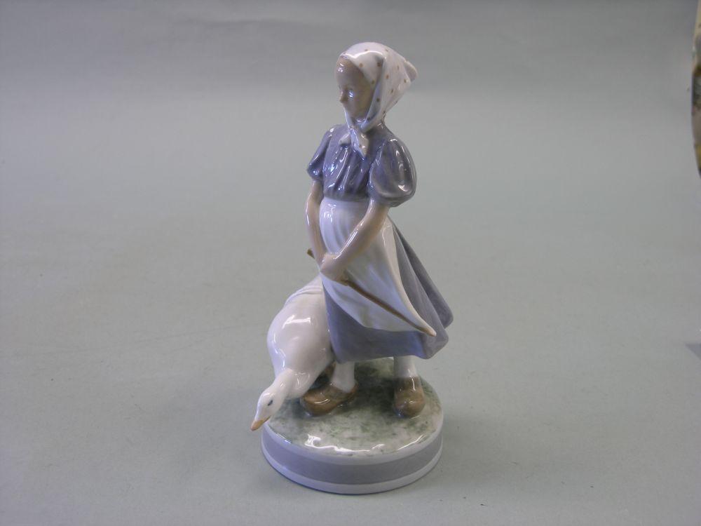 Appraisal: A Royal Copenhagen figure young female standing beside a goose