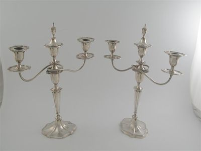 Appraisal: A pair of Edwardian three light candelabra on shaped oval