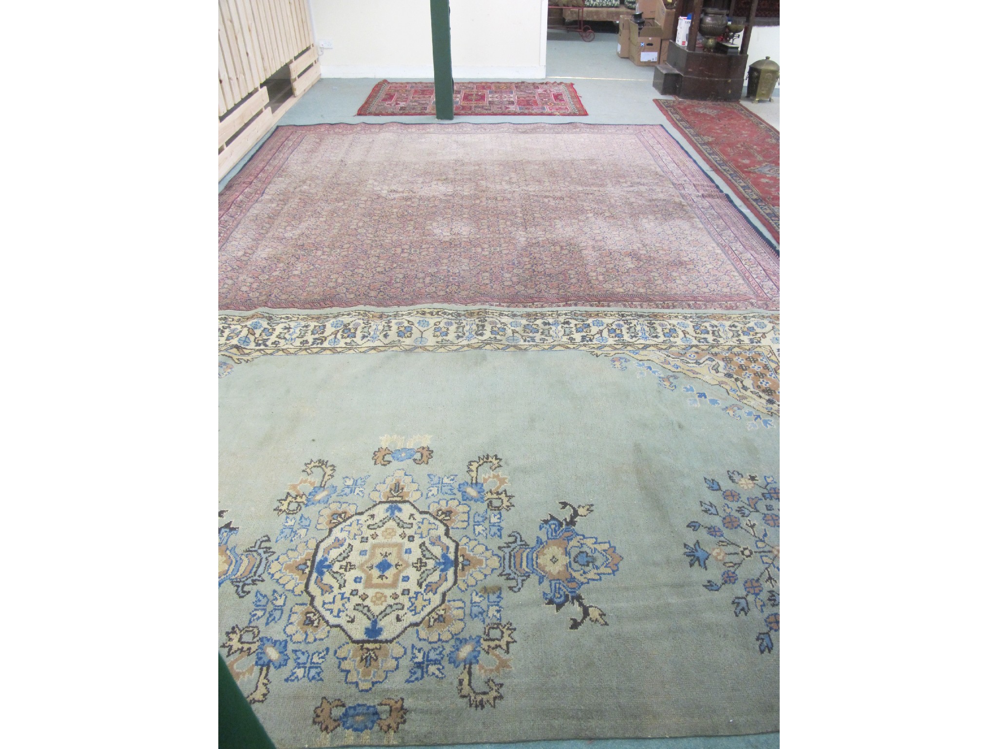 Appraisal: Two floral Persian style carpets with a similar rug damages