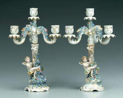 Appraisal: Pair porcelain candelabra encrusted with flowers base with cupids on