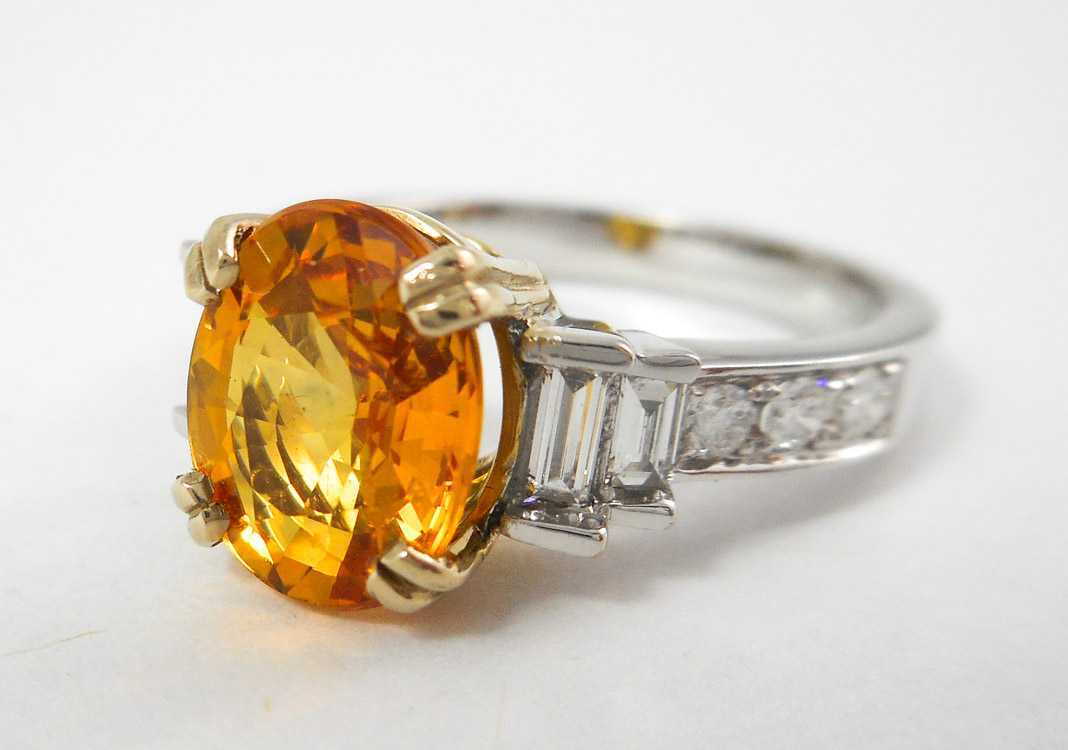 Appraisal: ORANGE SAPPHIRE AND DIAMOND RING k white and yellow gold