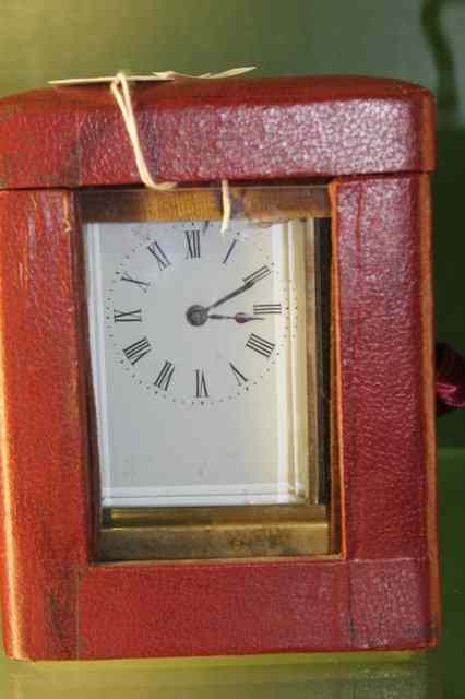 Appraisal: A BRASS CARRIAGE CLOCK WITH ENAMEL DIAL loop handle and