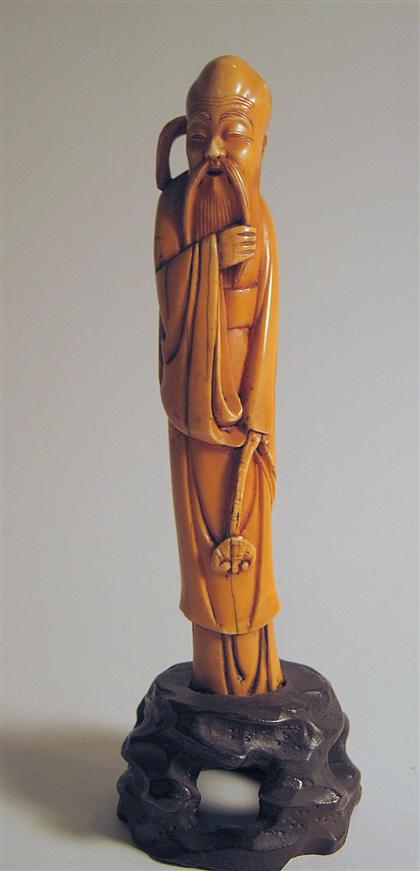 Appraisal: Chinese elephant ivory Shoulou figureSmall carving depicts The standing figure