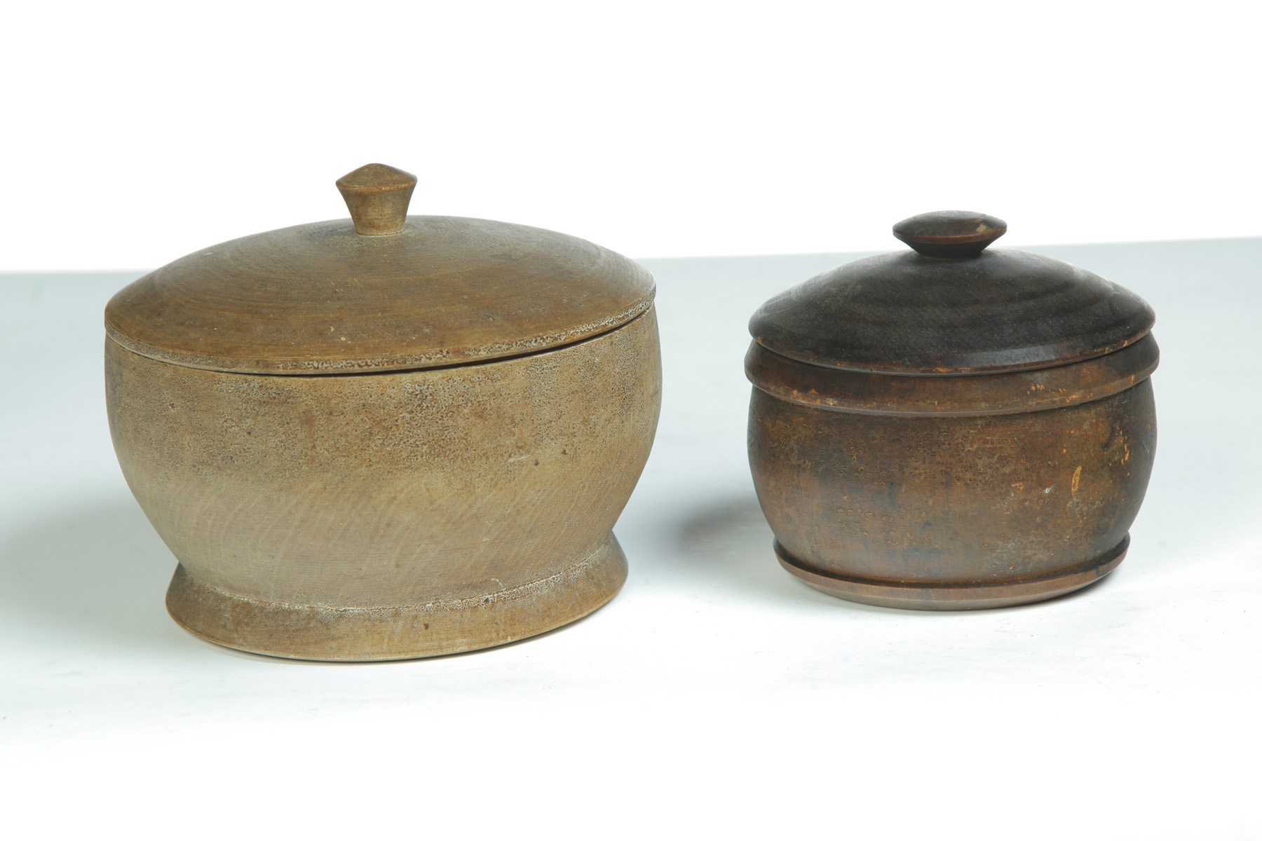 Appraisal: TWO TURNED LIDDED WOODEN JARS American rd quarter- th century