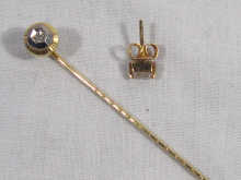 Appraisal: A diamond set stick pin together with a single diamond