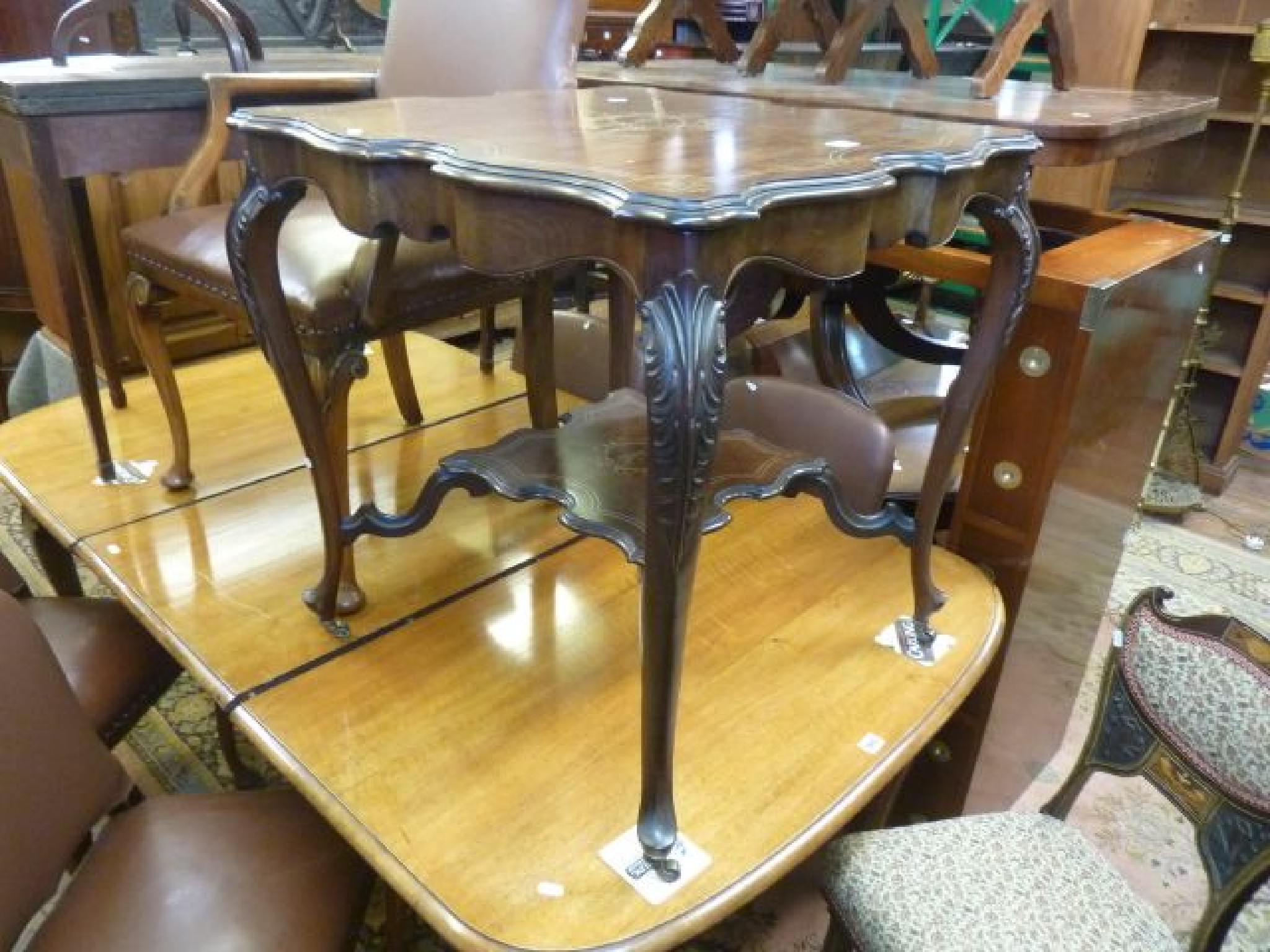 Appraisal: An inlaid Edwardian mahogany centre table with scalloped outline shaped