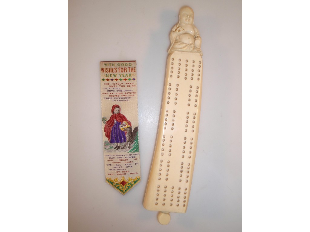 Appraisal: An ivory cribbage board surmounted by a figure of Hotei