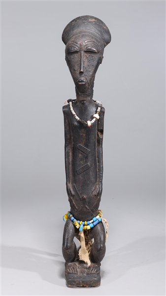 Appraisal: Wooden seated African figure with beaded details and carved designs