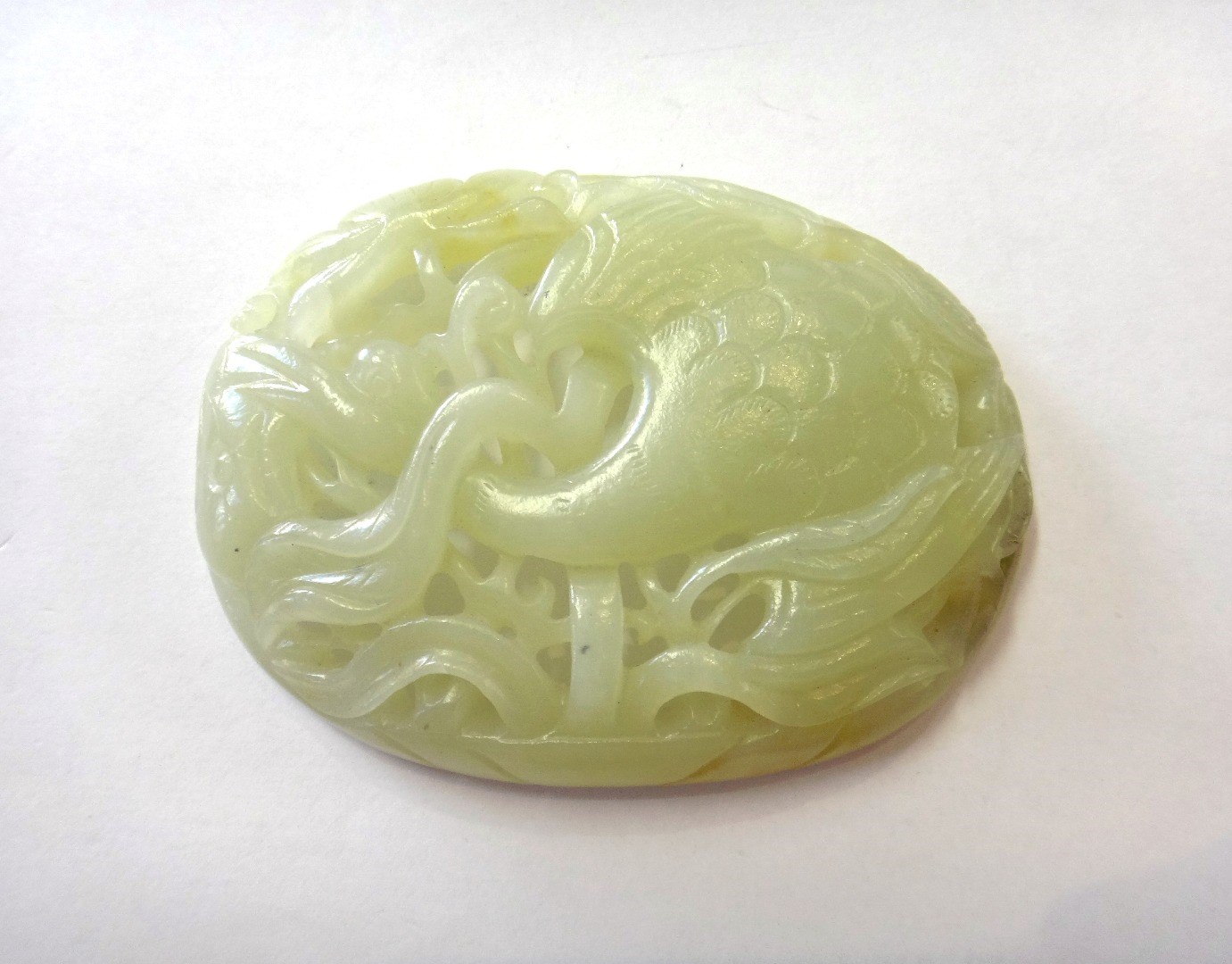 Appraisal: A Chinese jade oval plaque carved and pierced with a