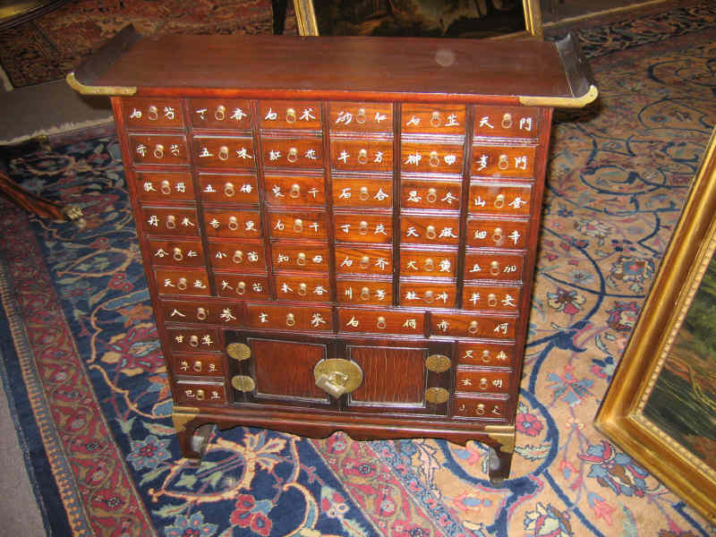 Appraisal: DIMINUTIVE ASIAN APOTHECARY CHEST Showing an assortment of small drawers