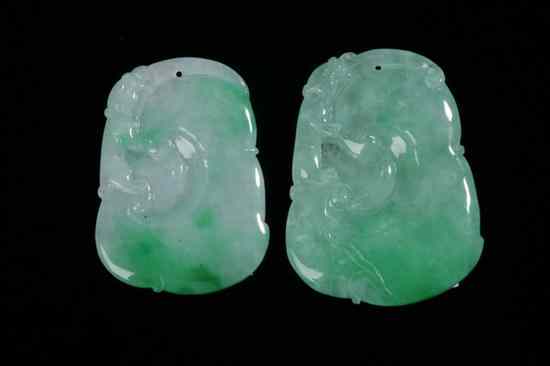 Appraisal: TWO CHINESE APPLE GREEN JADEITE PENDANTS Carved to depict ruyi