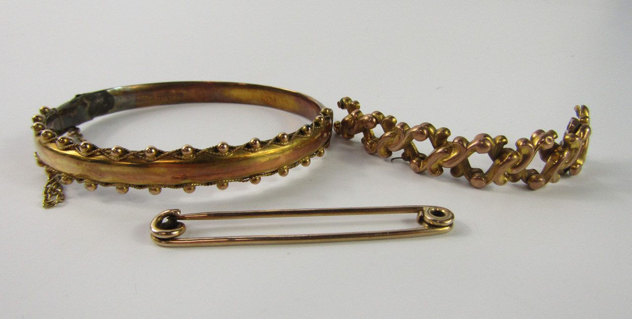 Appraisal: A ct gold bangle on a snap clasp with safety