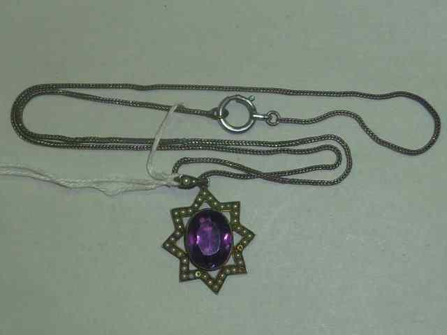 Appraisal: AN AMETHYST PENDANT in star shaped mount with pearl setting