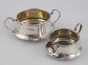 Appraisal: A silver cream jug and sugar bowl with unusual undulating