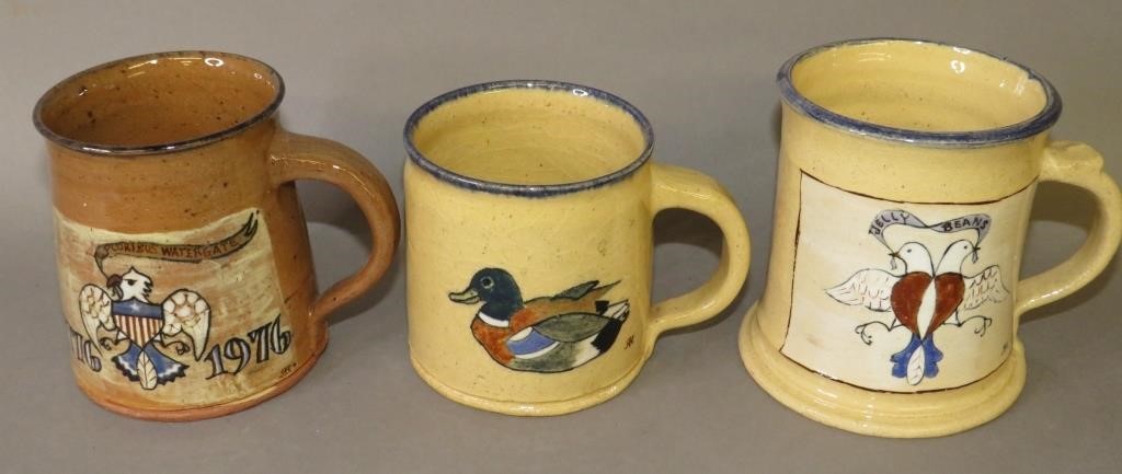 Appraisal: FOLK ART POTTERY HANDLED MUGS BY LEFT HANDED RUca all