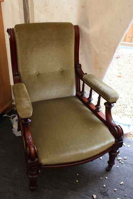 Appraisal: A VICTORIAN MAHOGANY UPHOLSTERED ARMCHAIR with carved scrolling supports and