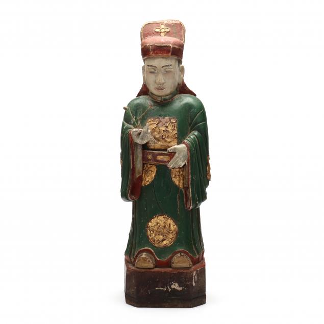 Appraisal: A CHINESE CARVED WOODEN FIGURE OF AN OFFICIAL Qing dynasty