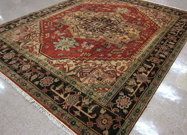 Appraisal: HAND KNOTTED ORIENTAL CARPET Persian Serapi design central geometric medallion