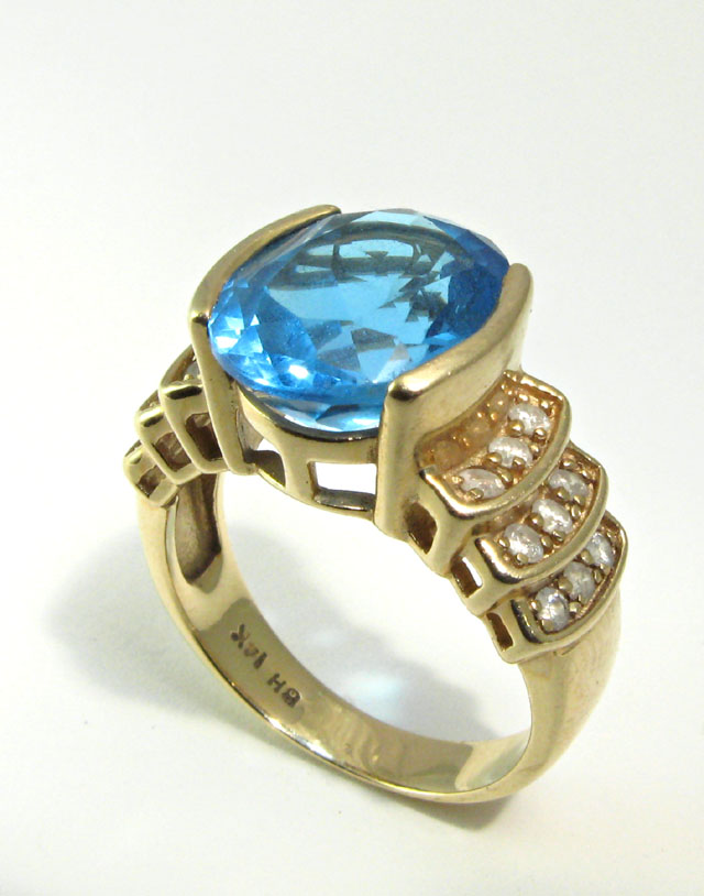 Appraisal: BLUE TOPAZ AND DIAMOND RING k yellow gold centering an