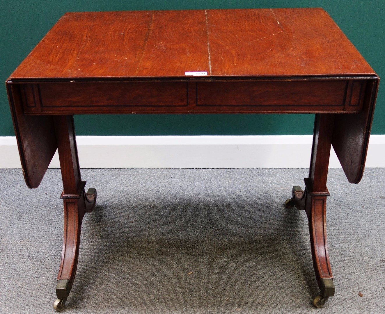 Appraisal: An early th century mahogany drop flap sofa table with