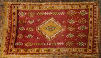 Appraisal: TURKISH ROSE-GROUND RUG AND A MACHINE-WOVEN LAVENDER-GROUND CARPET Together with