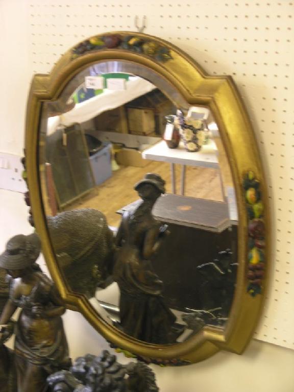 Appraisal: A gilt wall mirror lobed shape the frame carved and