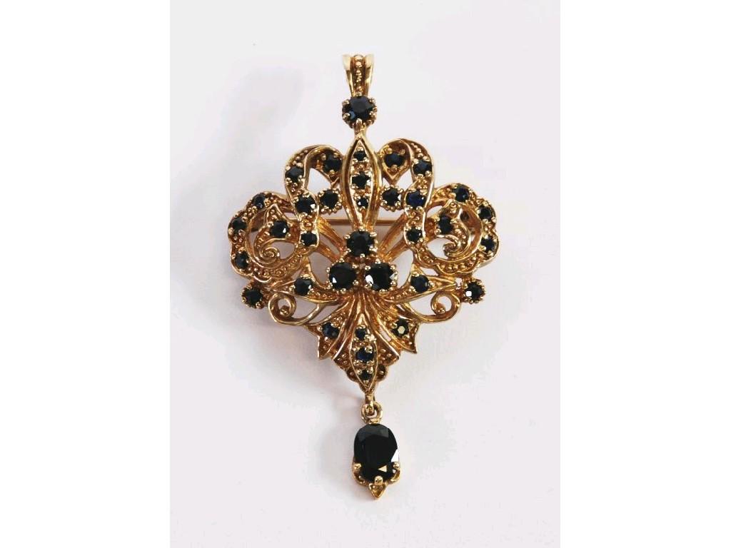 Appraisal: ct GOLD AND DARK SAPPHIRE SET OPENWORK SCROLL PENDANT with