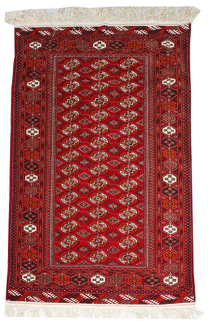 Appraisal: A MODERN TEKKE DARK RED GROUND RUG with three rows