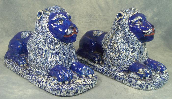 Appraisal: Pr blue faience crouching lions white decoration on mane and