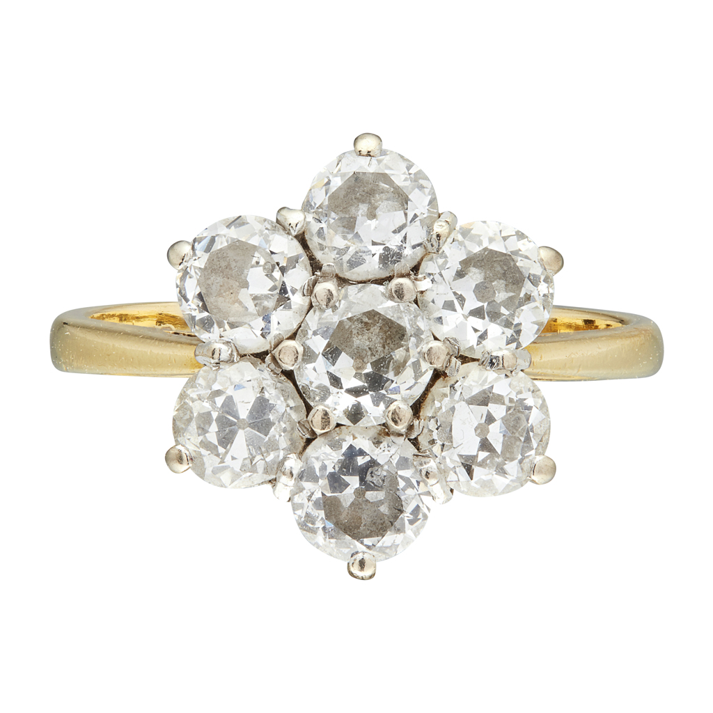 Appraisal: A diamond set cluster ring claw set with seven round