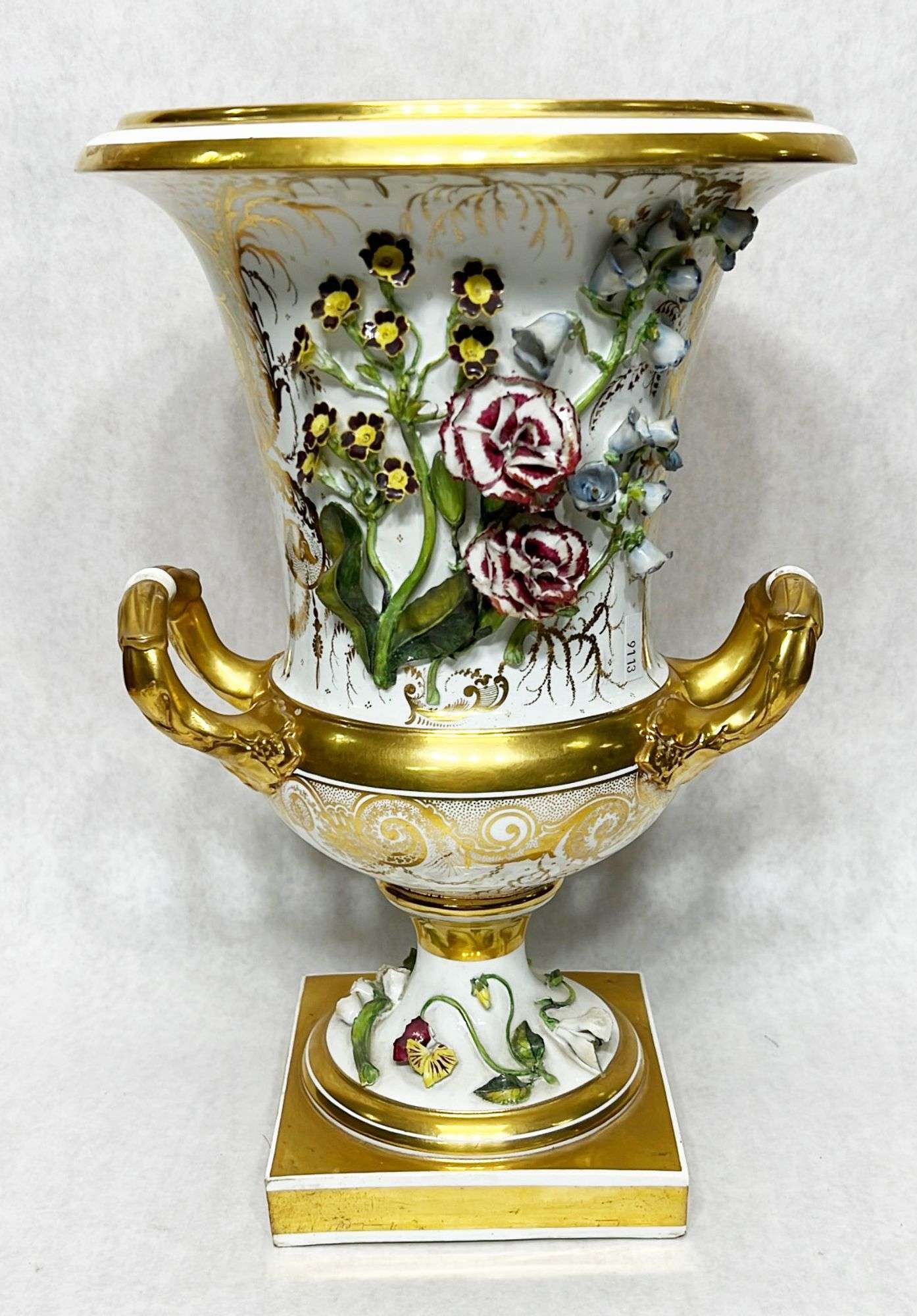 Appraisal: Continental Porcelain Gilt Decorated Urn with Applied Flowers tall Condition