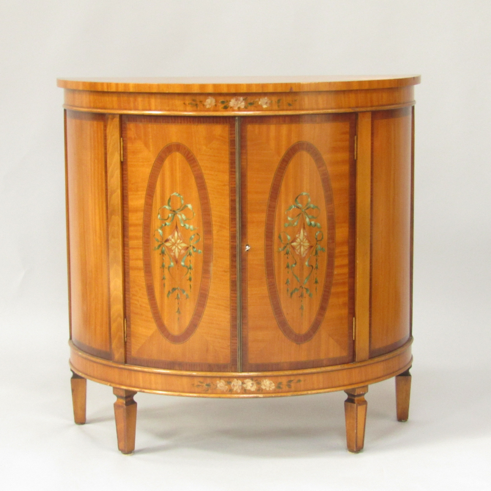 Appraisal: A Sheraton revival demi lune satinwood and painted side cabinet