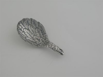 Appraisal: A George III eagle's wing caddy spoon with realistically textured