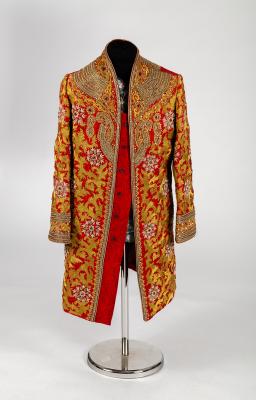 Appraisal: An Indian coat in claret paisley silk profuse decorated with