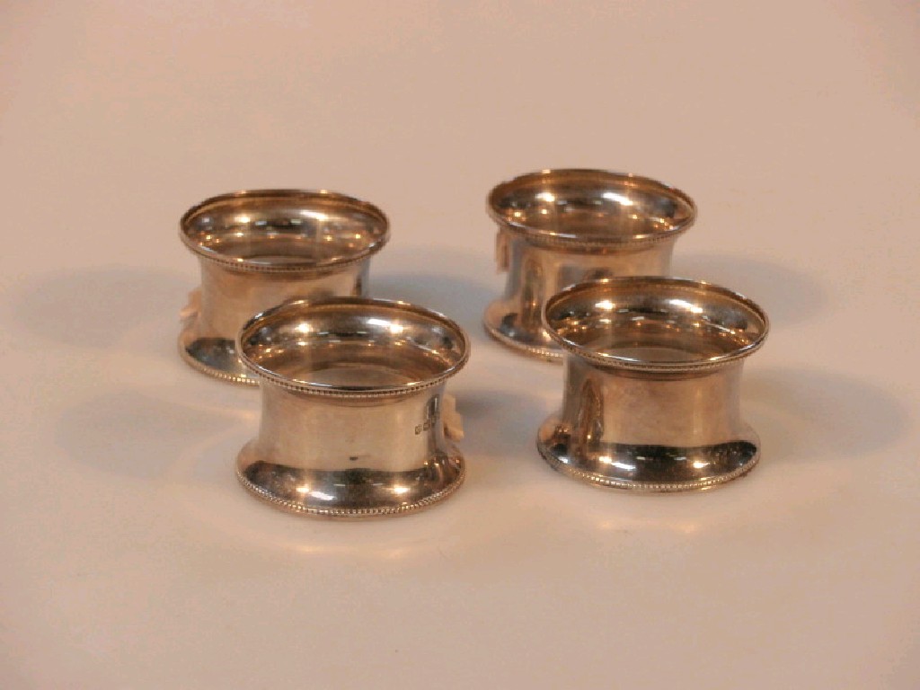 Appraisal: A set of four George V silver napkin rings Birmingham