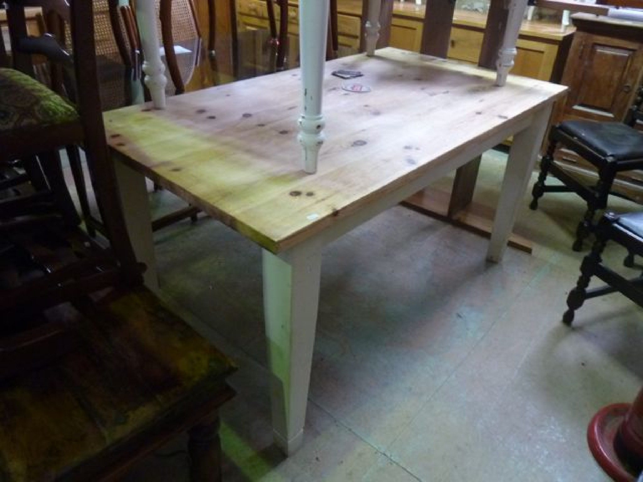 Appraisal: A pine kitchen table the stripped rectangular top raised on