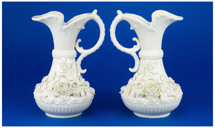 Appraisal: Pair of Early Belleek Floral Encrusted Ewers with a black