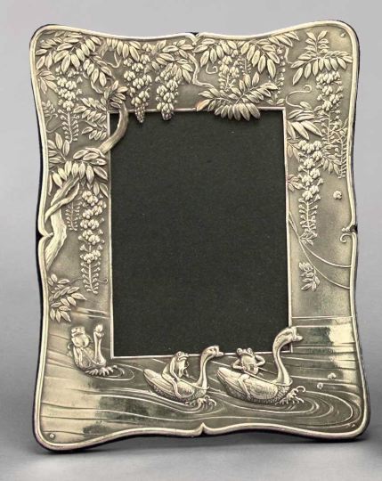 Appraisal: Whimsical English Embossed Sterling Silver-Faced Photograph Frame featuring a trio