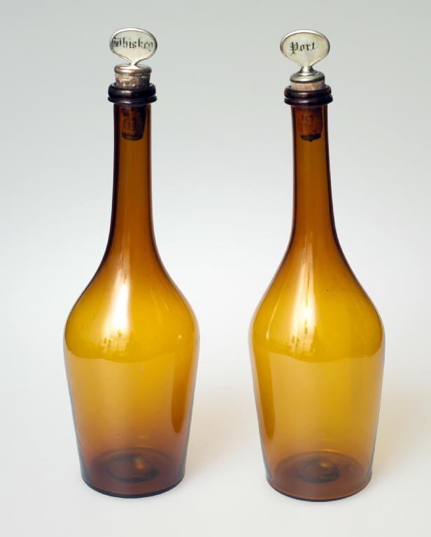 Appraisal: PAIR OF AMBER GLASS SERVING BOTTLES second quarter of the