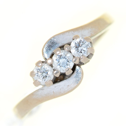 Appraisal: A three stone diamond crossover ring in ct white gold