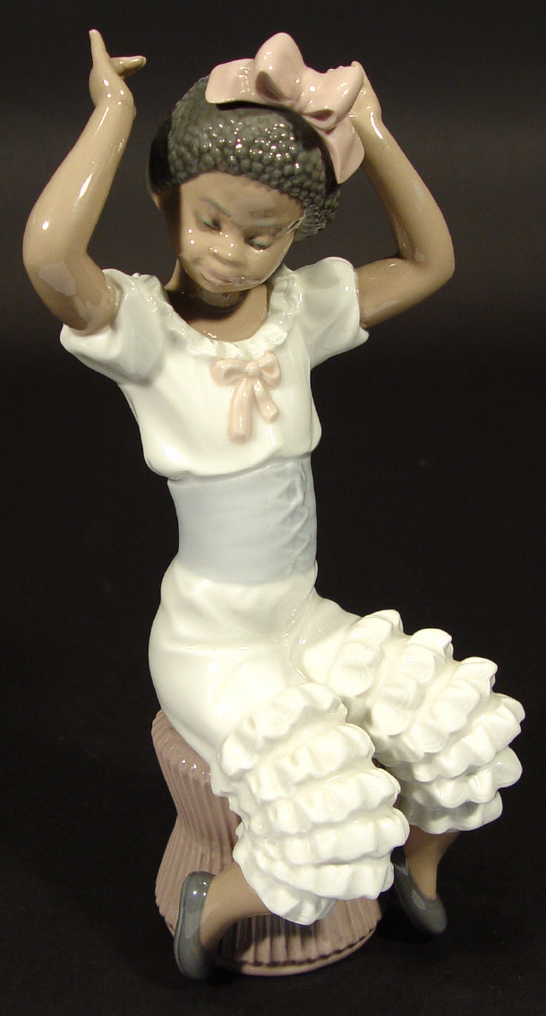 Appraisal: Lladro porcelain black girl seated on a stool with hand