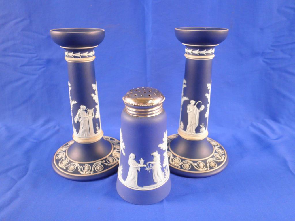 Appraisal: A pair of Victorian Wedgwood blue Jasperware candlesticks each decorated