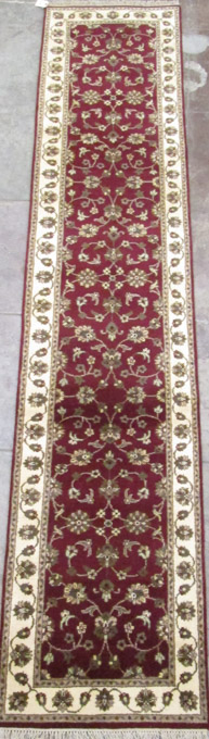 Appraisal: HAND KNOTTED ORIENTAL RUNNER Indo-Persian floral design on burgundy ground