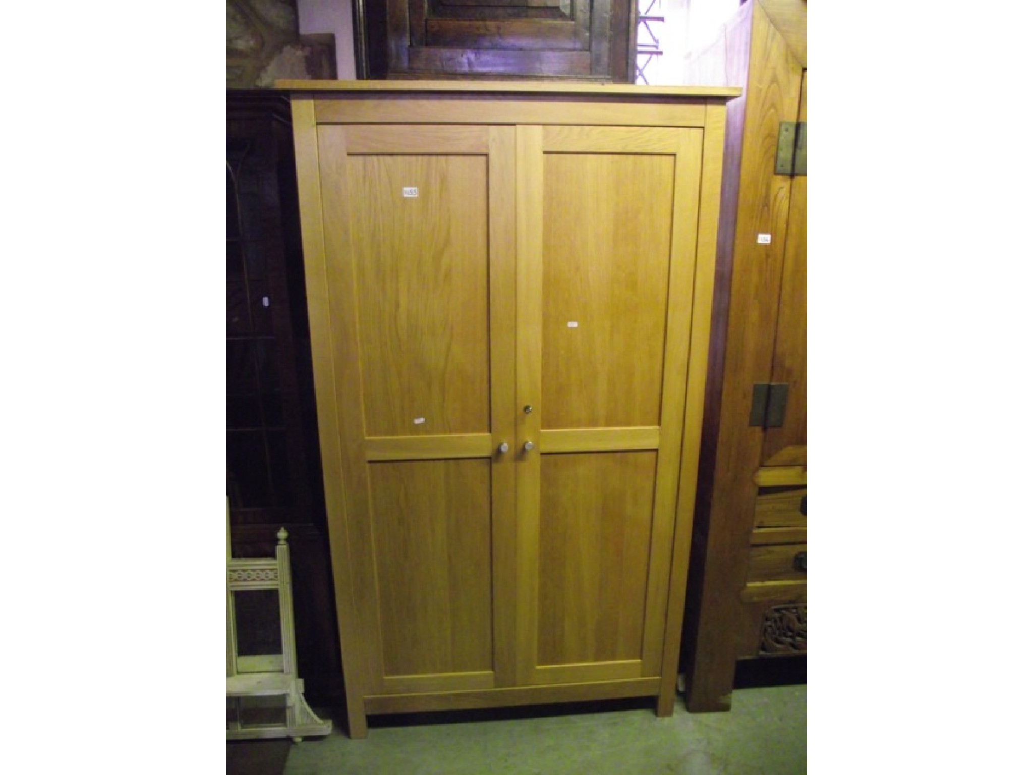 Appraisal: A contemporary light oak wardrobe enclosed by a pair of