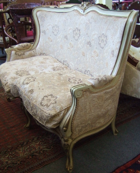 Appraisal: A th century shaped two seat sofa gilt heightened cream