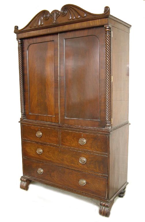 Appraisal: th century flamed mahogany linen press the scroll moulded cornice