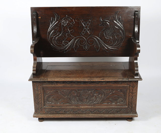 Appraisal: A CHIP CARVED OAK MONK'S BENCH with adjustable back and