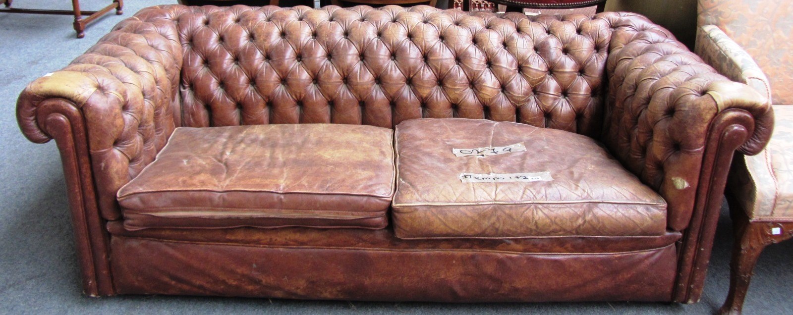 Appraisal: A th century brown leather Chesterfield sofa with button back