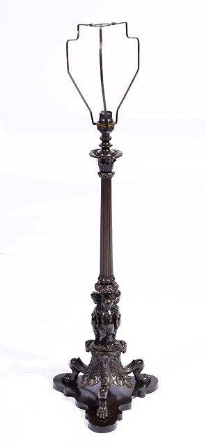 Appraisal: AN ITALIANATE BRONZE LAMP STANDARD with figural mounts and triform