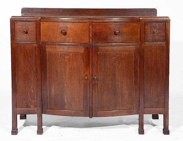 Appraisal: A Heals oak sideboardcirca with bow front and four short